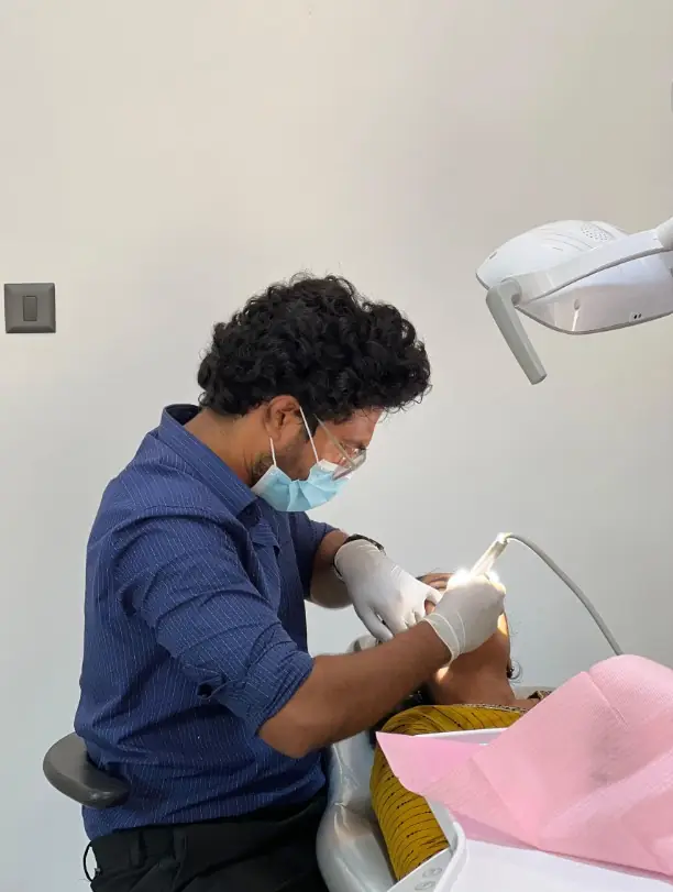 Dr. Praveen treating a patient at Diamond Dental Clinic