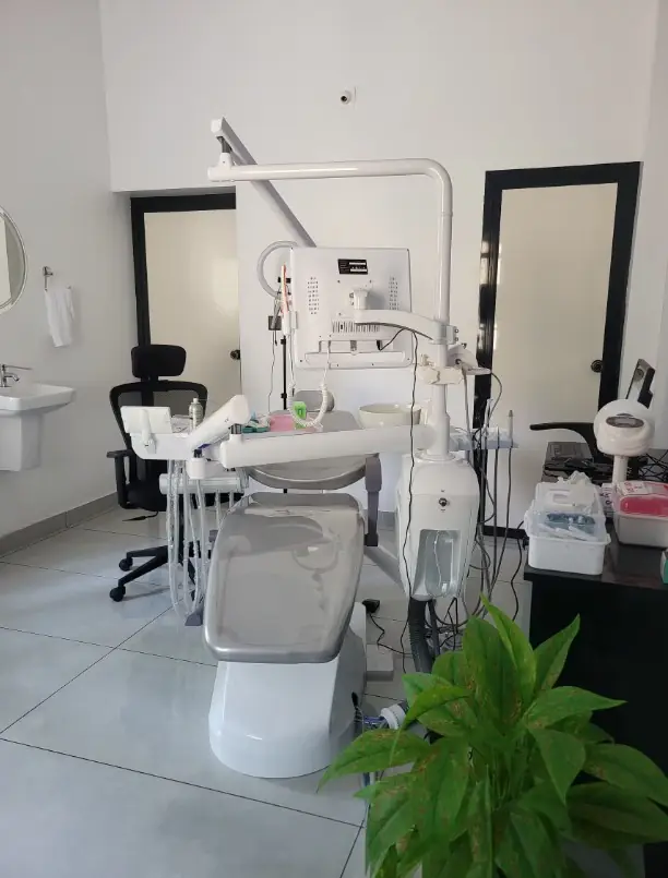 Clean, modern treatment room with dental unit and monitor