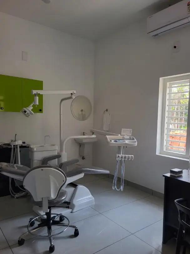Bright treatment room with dental chair and window